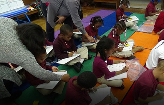 People teaching small children inside a room