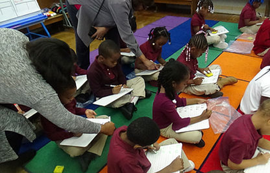 People teaching small children inside a room